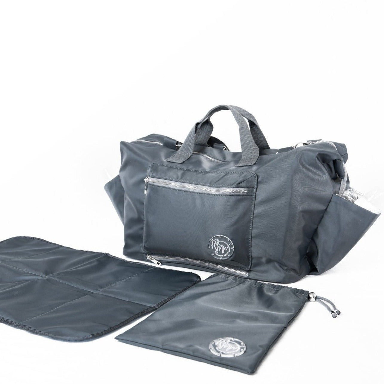 alt="The DUFFLE Nappy Bag with change mat and Oopsie Daisy Wet Bag. All in Chaos + Calm (charcoal grey)"